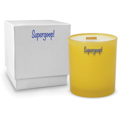 Yellow colored-glass 14 oz candle beside a glossy white gift box.