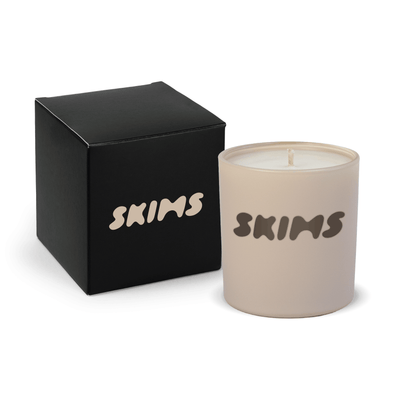 Nude 9 oz. printed colored glass candle paired with a matte black gift box.