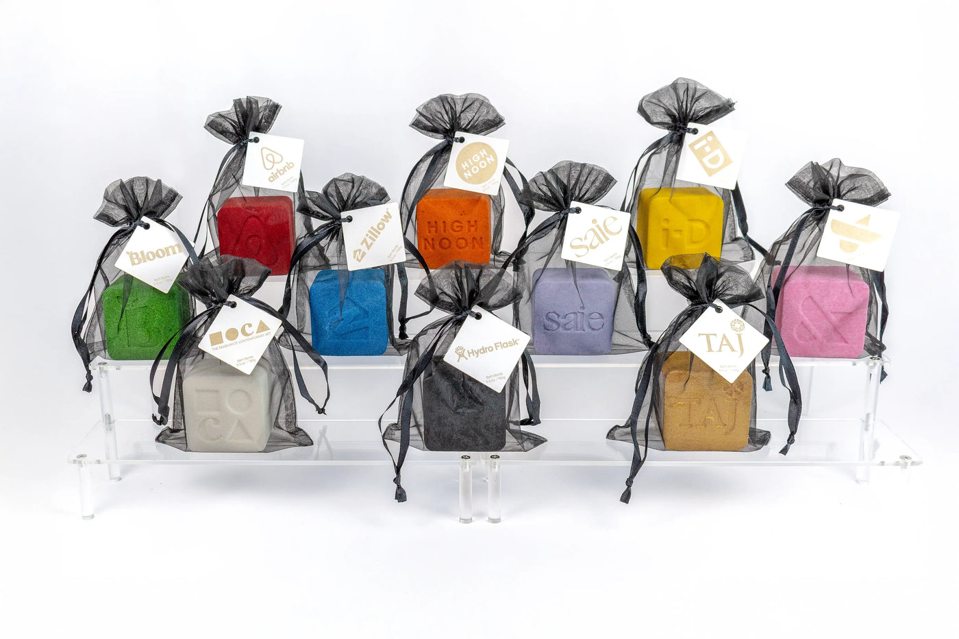Custom Candles LA bath bombs in assorted colors, packaged in a sheer organza gift bag