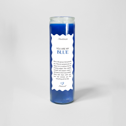 A tall cylindrical candle in a glass container filled with blue wax titled "You are my BLUE" on a white label with scalloped edges. The label also includes a note explaining what the color blue represents followed by a blue heart at the bottom.