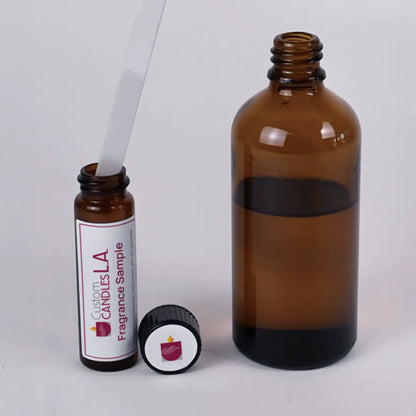 Two amber glass bottles with dropper and cap on a light gray background