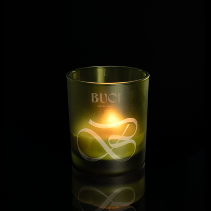 Green 14 oz. Luxury Engraved Candle lit, shown on a black background.