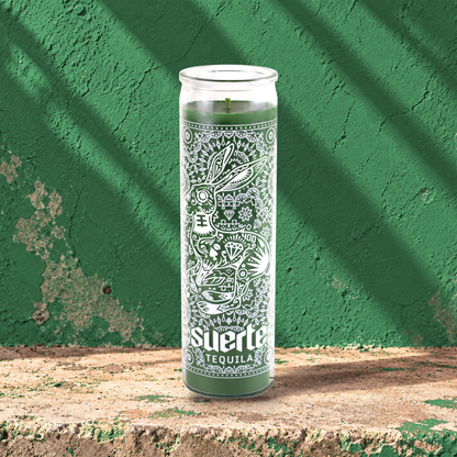 Green 16 oz custom prayer candle printed with the Suerte Tequila logo on a green background, unlit
