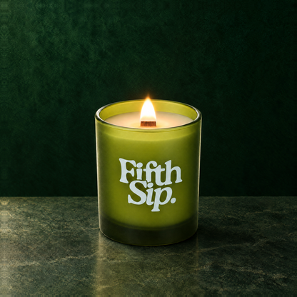 Green 14 oz. Luxury Printed Candle lit with a printed custom logo, shown on a matching green background.