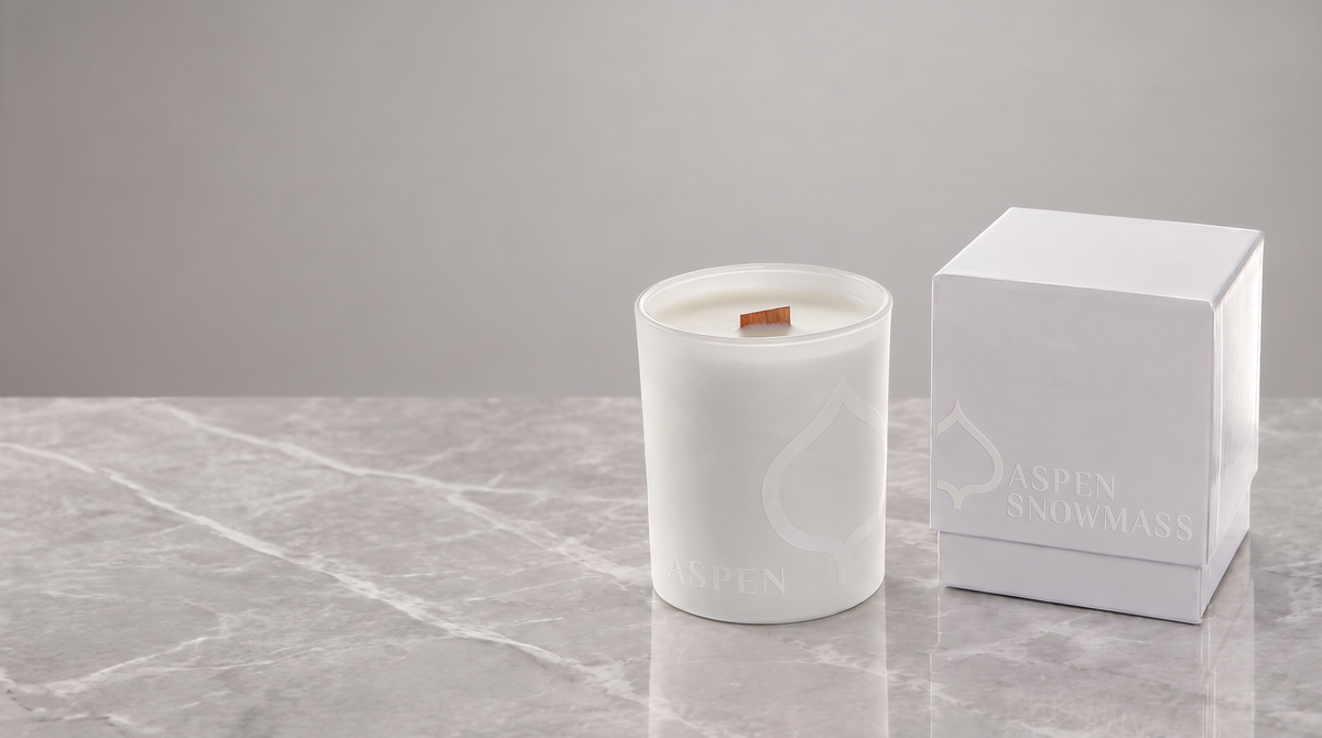 White 14 oz. printed luxury candle with a tone-on-tone logo on a light marble surface