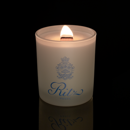 Ivory 14 oz. Luxury Printed Candle lit, shown on a black background.