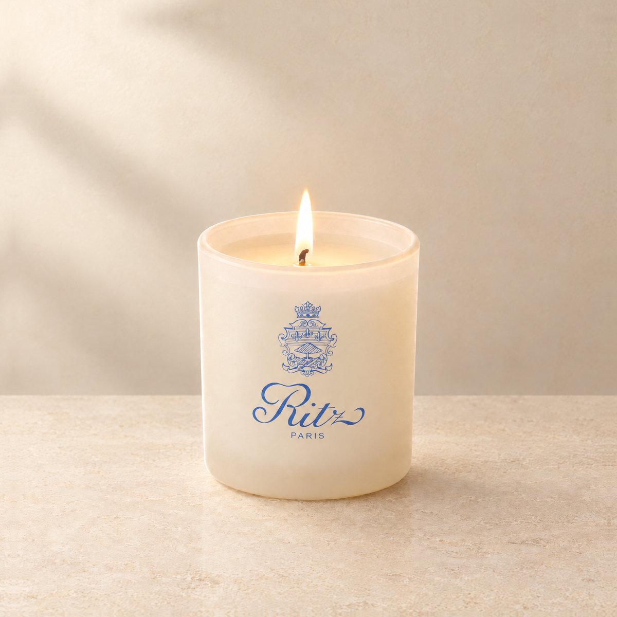 Ivory 9 oz. Classic Printed Candle lit with a printed custom logo, shown on a matching ivory background.
