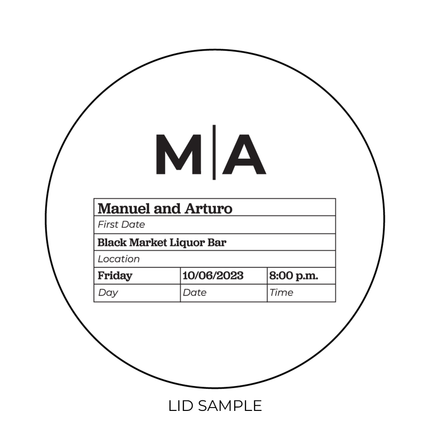 A sample of the wooden lid for the "For the Record Monogram" Candle by Custom Candles L.A. features a monogram "M|A" along with a grid of information about the First date for Manuel and Arturo, date, location, day, and time.