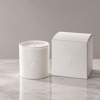Matte white 9 oz. Classic Candle with a tone-on-tone Lamborghini shield logo beside its matching white gift box on a grey marble surface, made in Los Angeles by Custom Candles LA