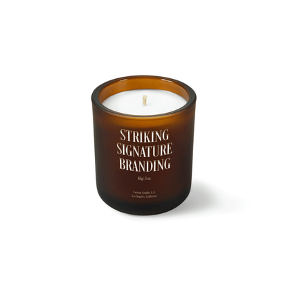 Amber frosted 3 oz Mini Signature candle with a laser-engraved custom logo, shown on its own.