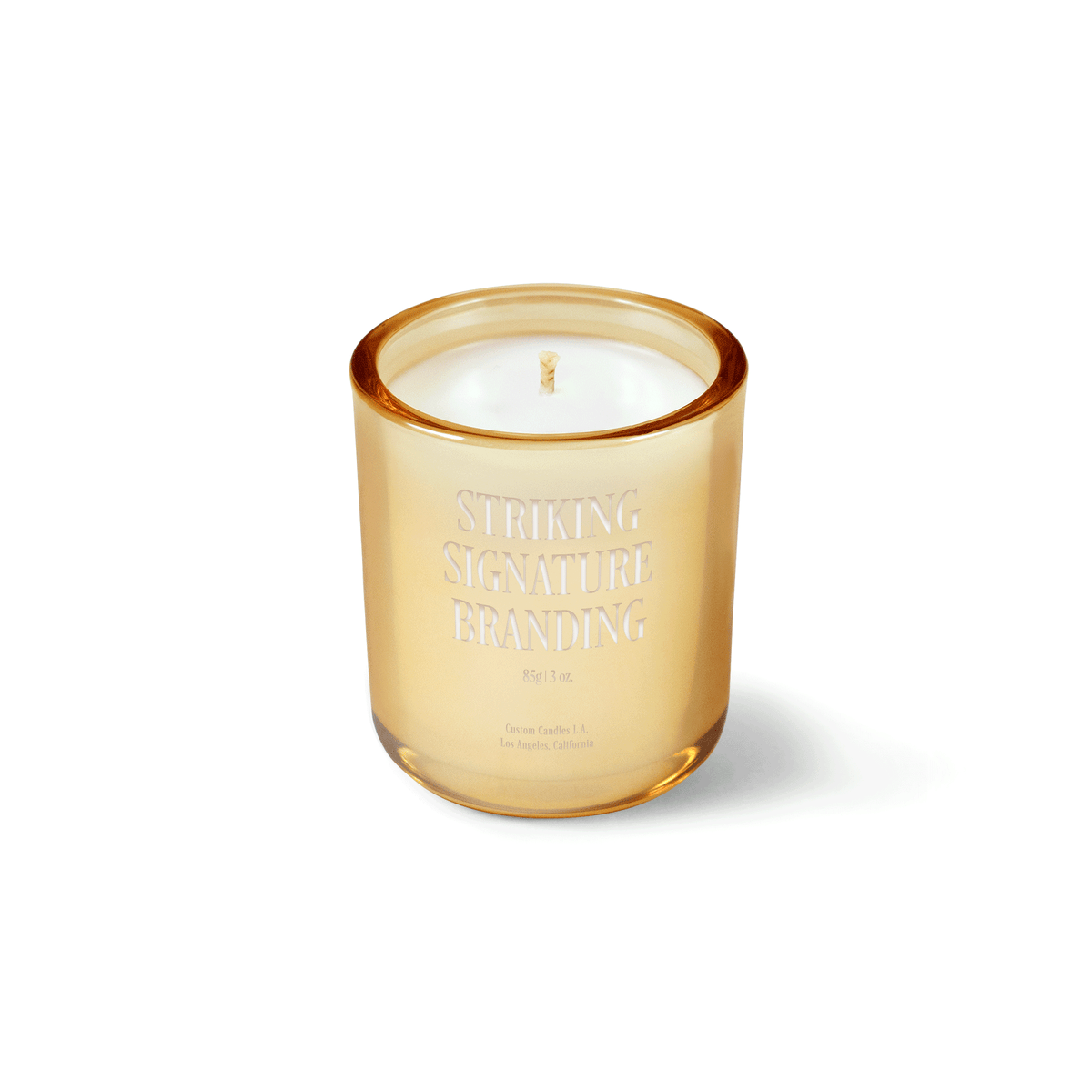 Glimmering gold 3 oz Mini Signature candle with a laser-engraved custom logo, shown on its own.