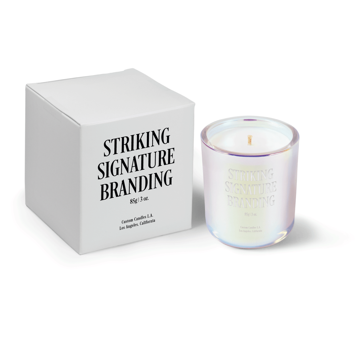 Iridescent pink 3 oz Mini Signature candle, engraved, shown beside its gift box.