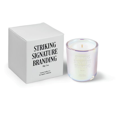 Iridescent pink 3 oz Mini Signature candle, engraved, shown beside its gift box.