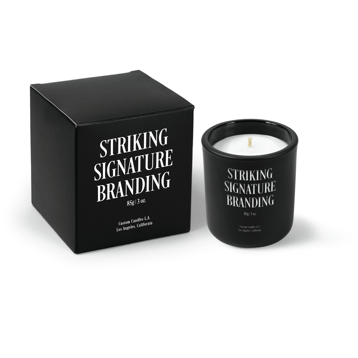 Jet black 3 oz Mini Signature candle, engraved, shown beside its gift box.