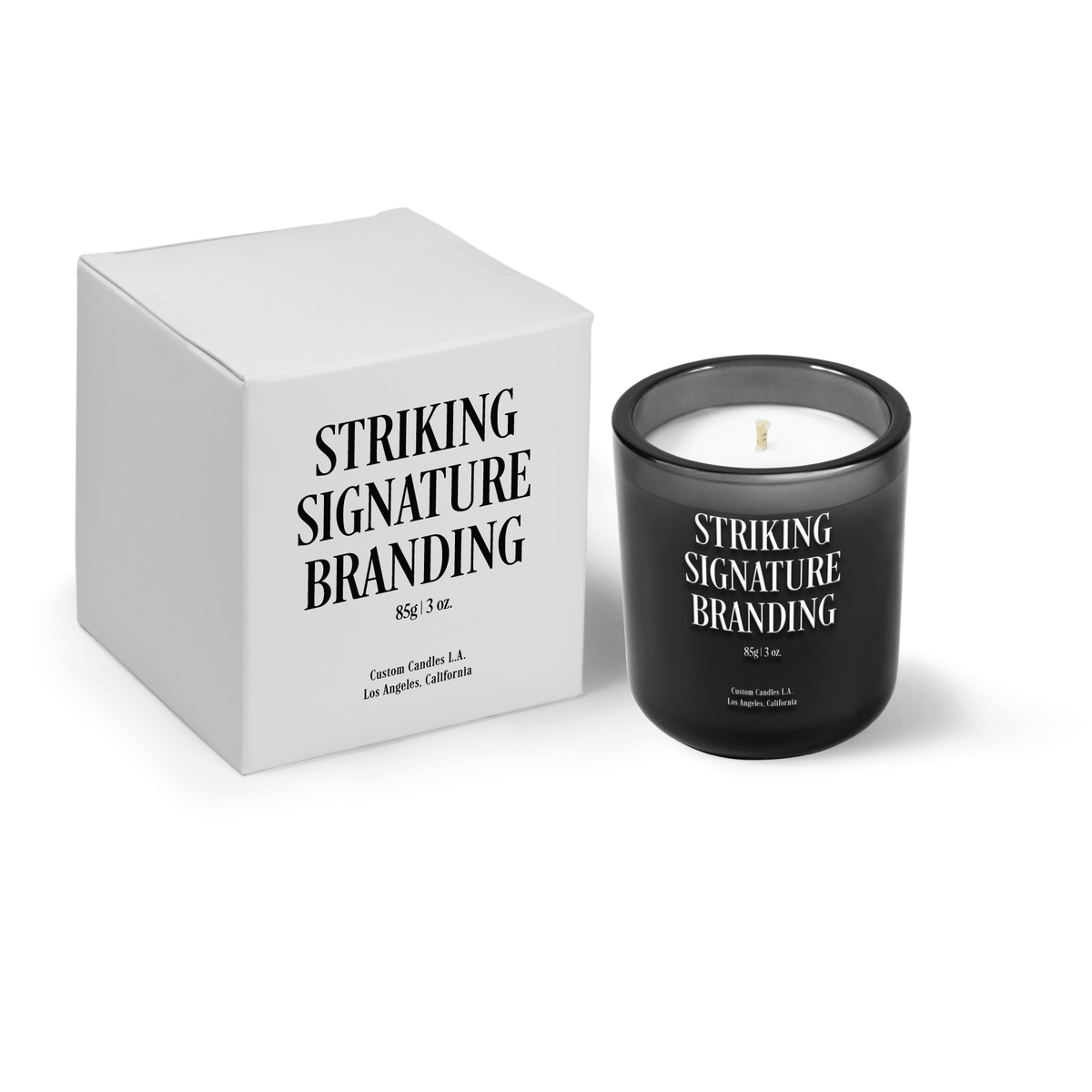 Charcoal gray 3 oz Mini Signature candle, engraved, shown beside its gift box.