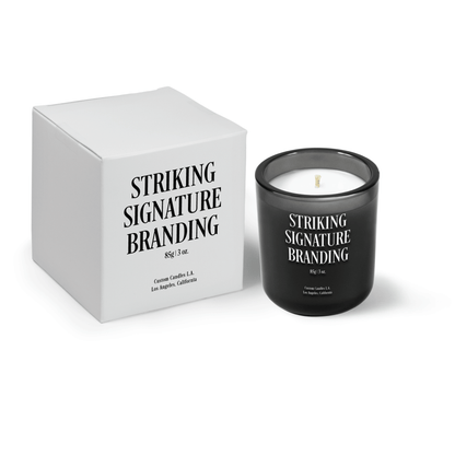 Charcoal gray 3 oz Mini Signature candle, engraved, shown beside its gift box.