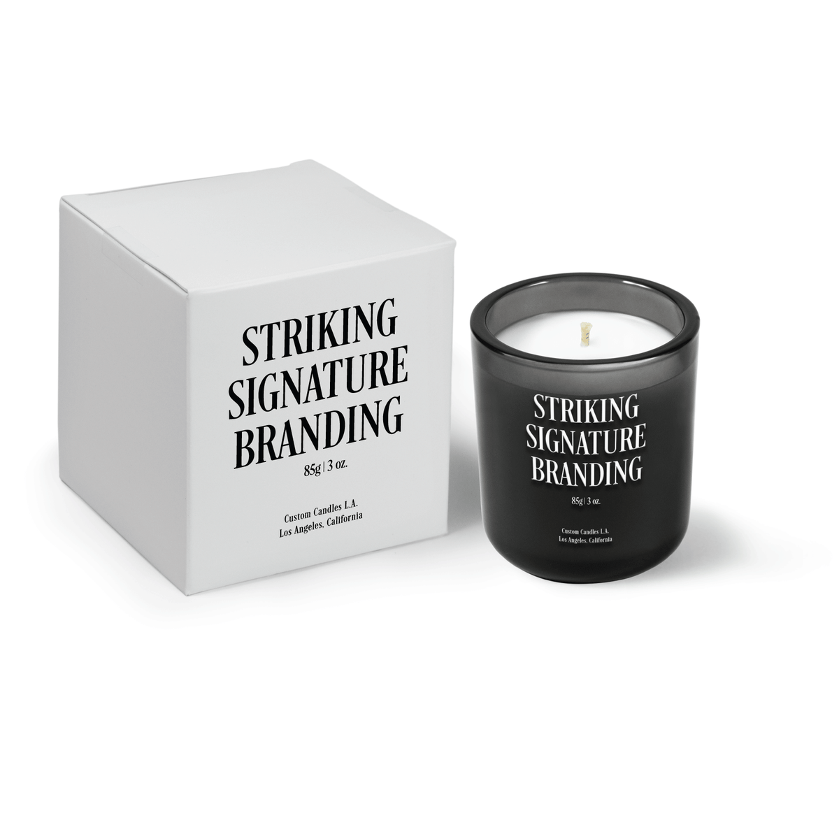 Charcoal gray 3 oz Mini Signature candle, printed, shown beside its gift box.