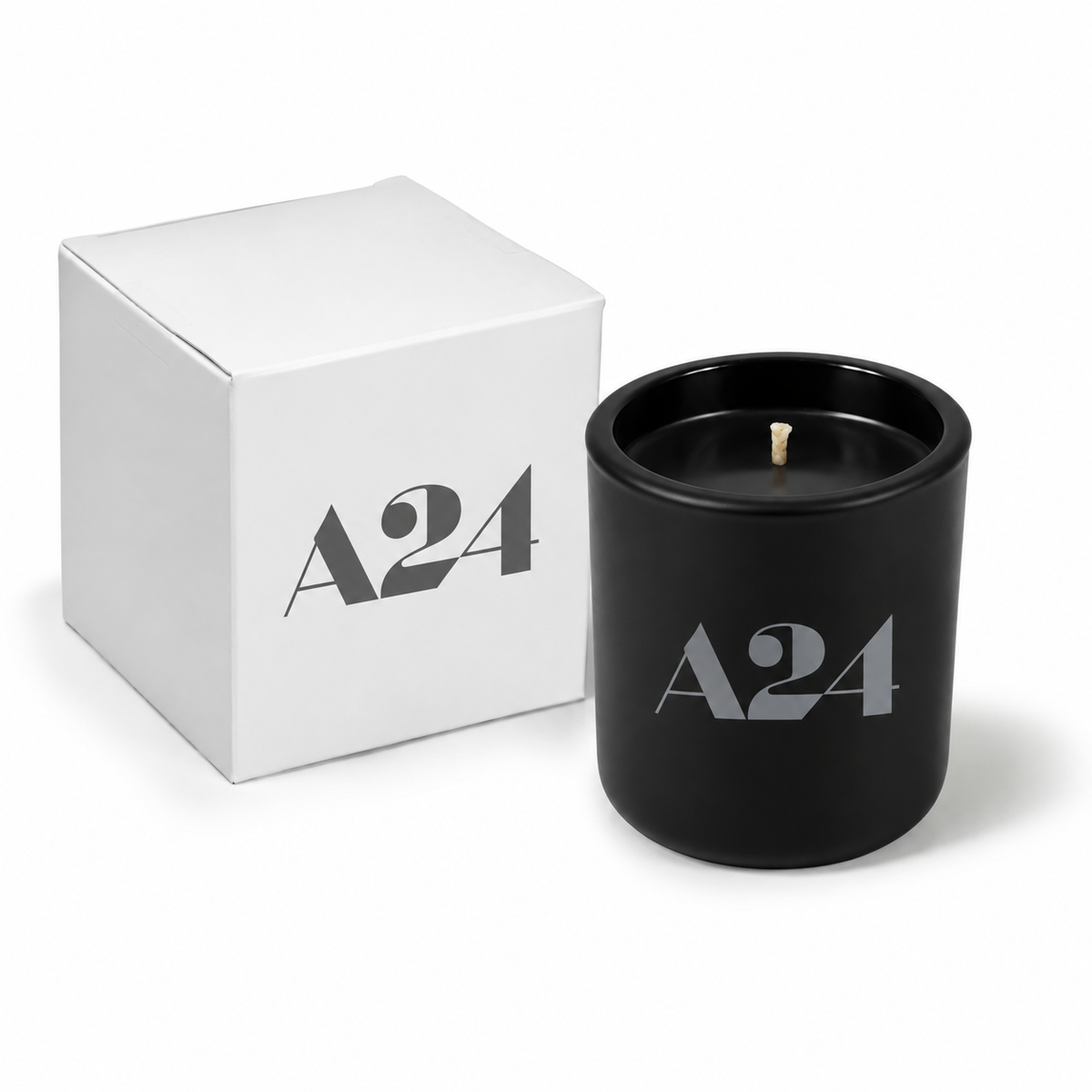Jet black 3 oz Mini Signature candle poured with black wax, shown beside its gift box.