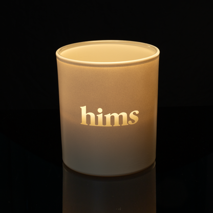 Nude 14 oz. Luxury Engraved Candle lit, shown on a black background.