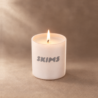 Nude 9 oz. Classic Printed Candle lit with a printed custom logo, shown on a matching nude background.