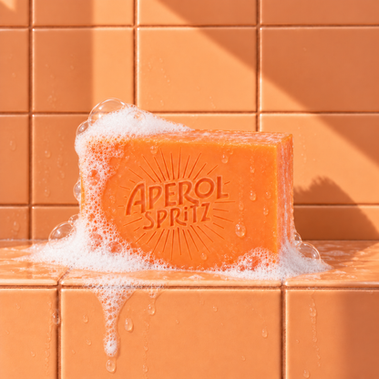 Orange rectangle bar soap laser engraved with a brand logo, 3.25 oz, with soap bubbles
