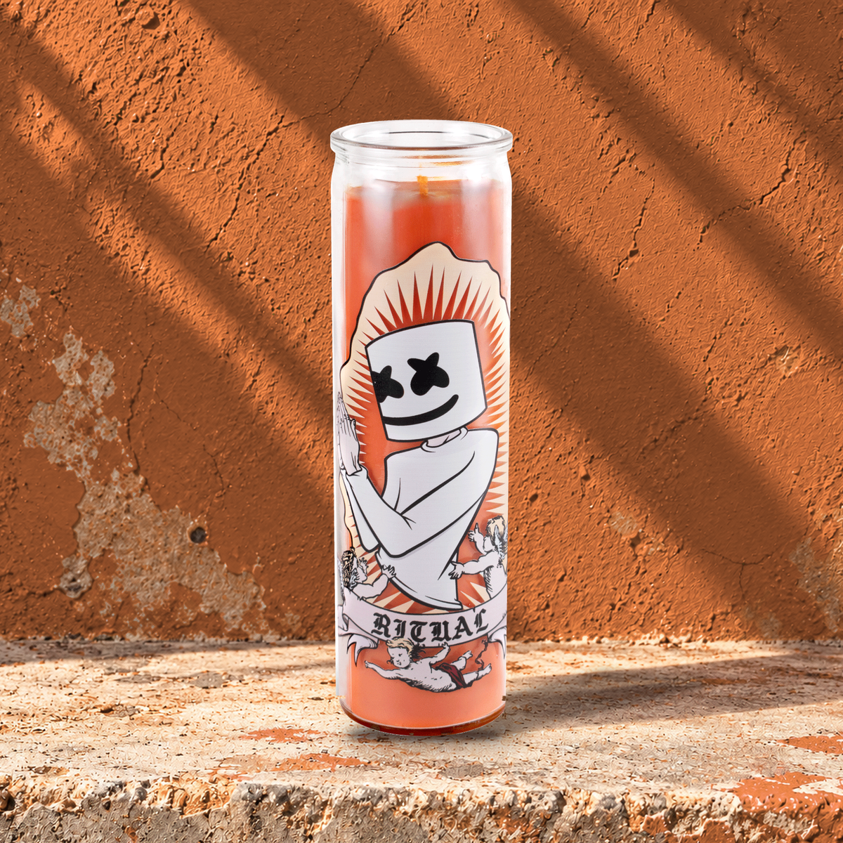 Orange 16 oz custom prayer candle printed with the Ritual logo on an orange background, unlit