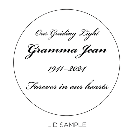 A sample of the wooden lid for the "Memorial Photo" Candle by Custom Candles L.A. features the message "Our Guiding Light Gramma Jean 1941-2024 Forever in our hearts" in script.