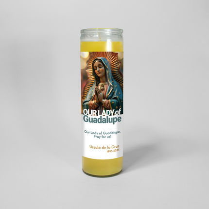 This image shows a 16 oz prayer candle from Custom Candles LA. It features Our Lady of Guadalupe with the text "Our Lady of Guadalupe, Pray for us!" and personalized with "Ursula de la Cruz 1945-2025."