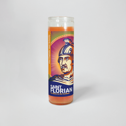  This image shows a 16 oz prayer candle from Custom Candles LA. It has orange wax in a tall glass container with a vibrant pop-art Saint Florian design. "Fire Captain Joel Schmitt" is printed on the label, honoring firefighters.