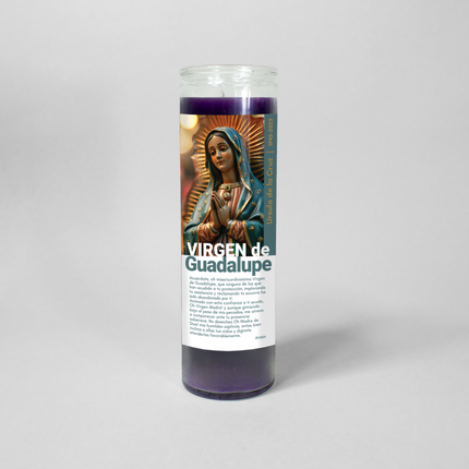 This image shows a 16 oz purple prayer candle from Custom Candles LA. It features a vibrant illustration of Virgen de Guadalupe with the text "Virgin de Guadalupe" and a scripture in Spanish printed on the label customized with a name and date running up the side of the candle.