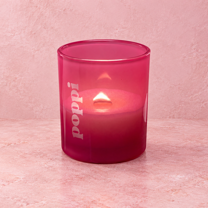 Pink 14 oz. Luxury Engraved Candle with a custom engraved logo, lit.