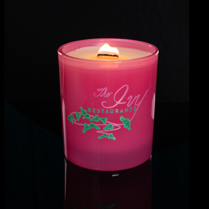 Pink 14 oz. Luxury Printed Candle lit, shown on a black background.