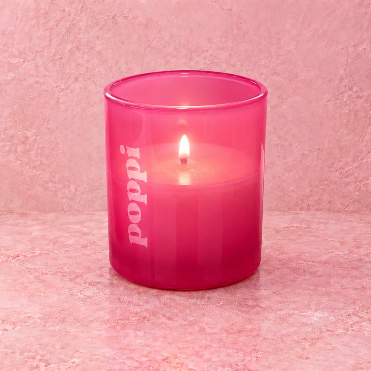 Pink 9 oz. Classic Engraved Candle with a custom engraved logo, lit.