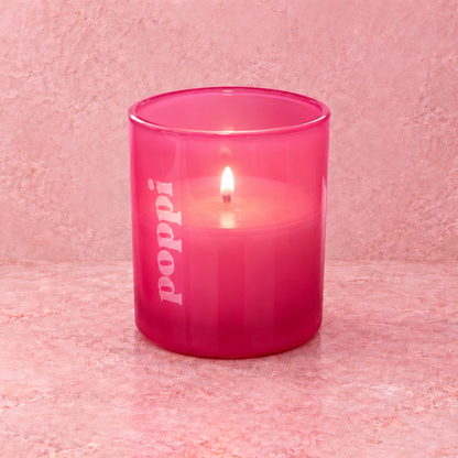 Pink 9 oz. Classic Engraved Candle with a custom engraved logo, lit.