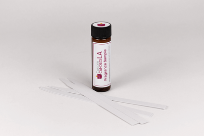 Fragrance sample bottle with sticks on a white background