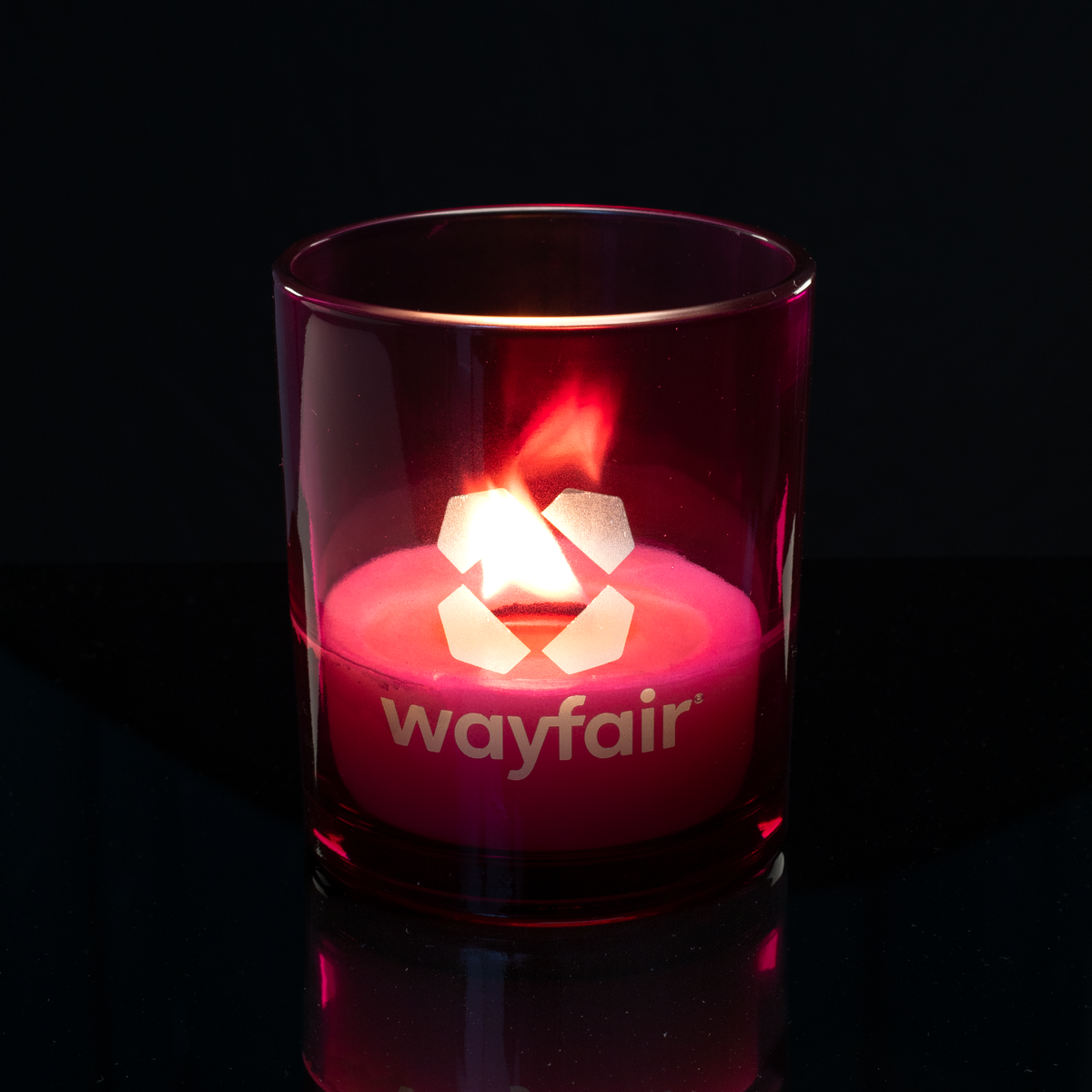 Purple 14 oz. Luxury Engraved Candle lit, shown on a black background.