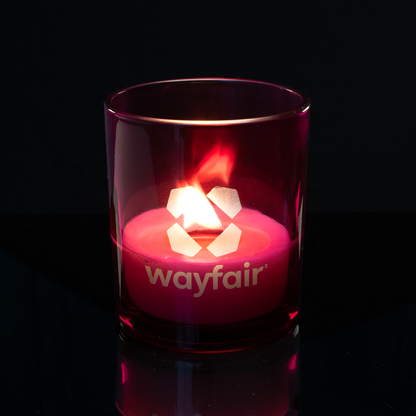 Purple 14 oz. Luxury Engraved Candle lit, shown on a black background.