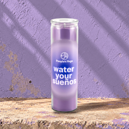 Purple 16 oz custom prayer candle printed with the People's Yoga logo on a purple background, unlit