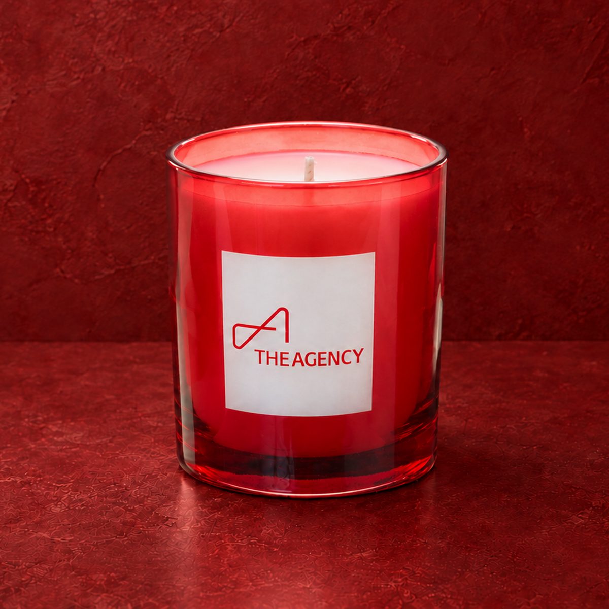 Red 9 oz. Classic Engraved Candle with a custom engraved logo, unlit.