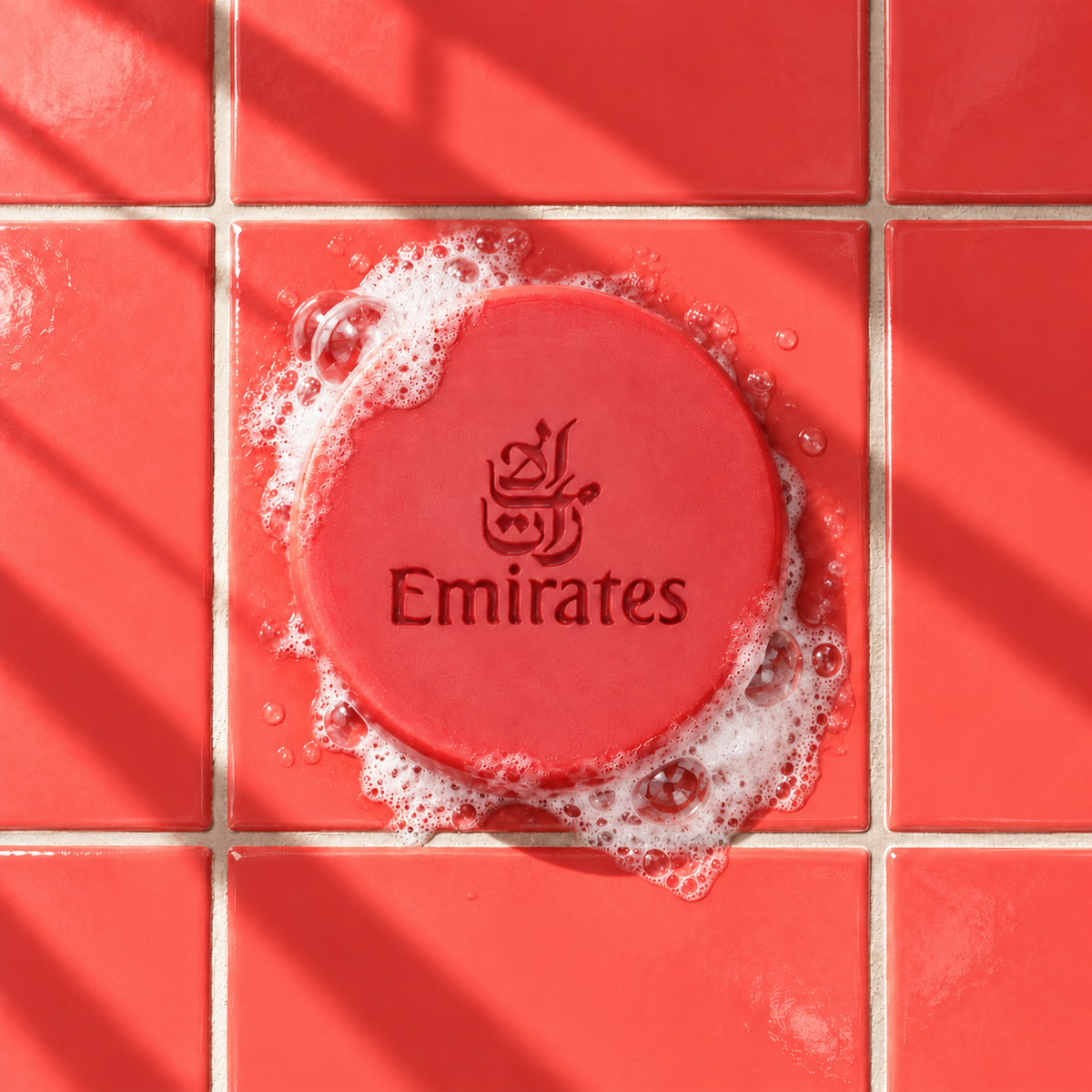Red round bar soap laser engraved with a brand logo, 3.6 oz, with soap bubbles