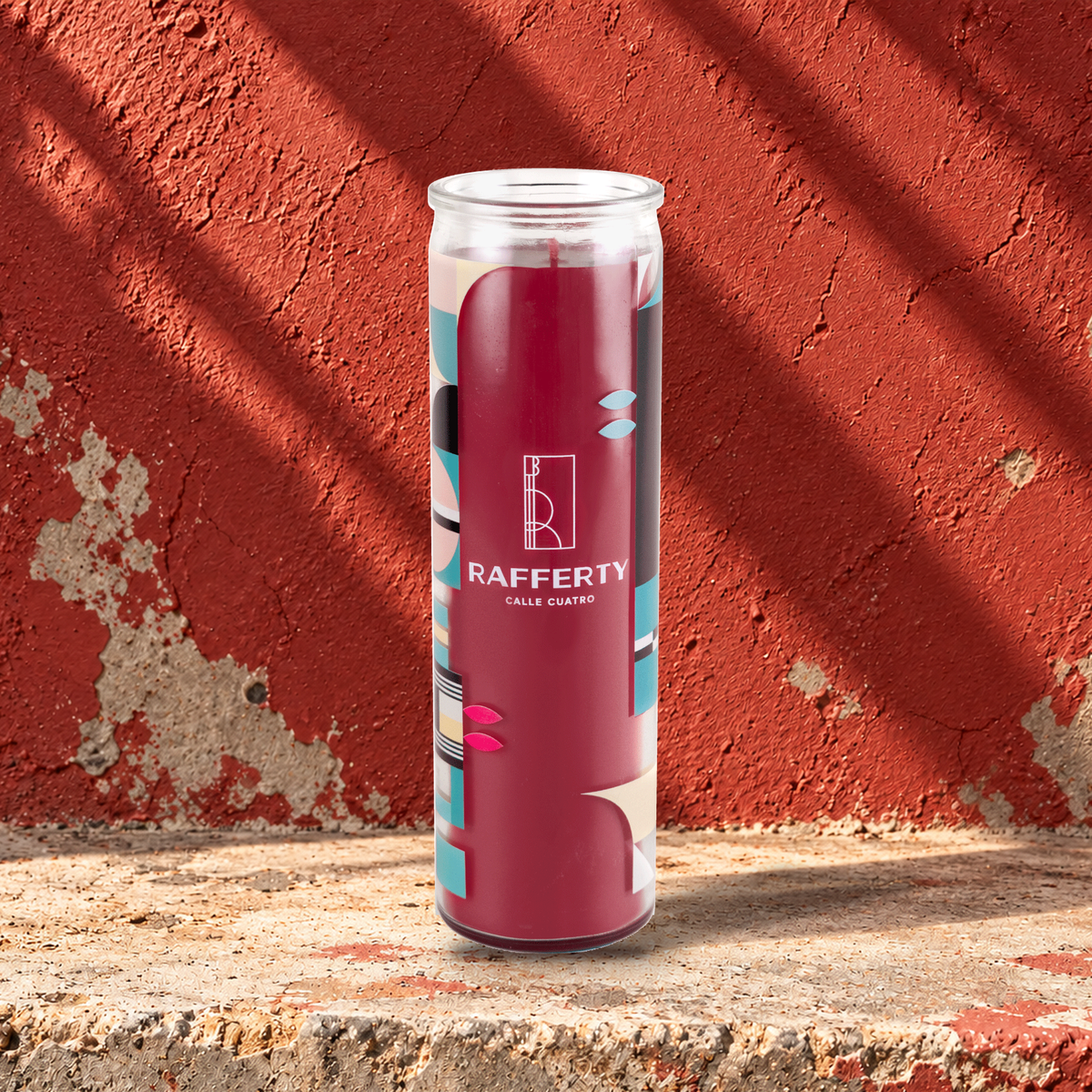 Red 16 oz custom prayer candle printed with the Rafferty logo on a red background, unlit