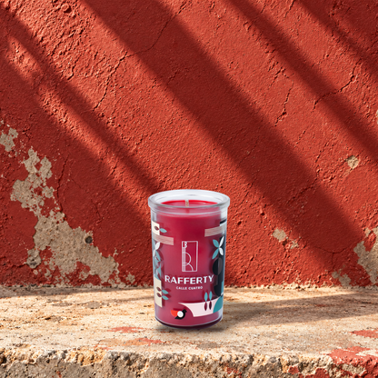 Red 5 oz custom mini prayer candle printed with the Rafferty logo on a red background, unlit