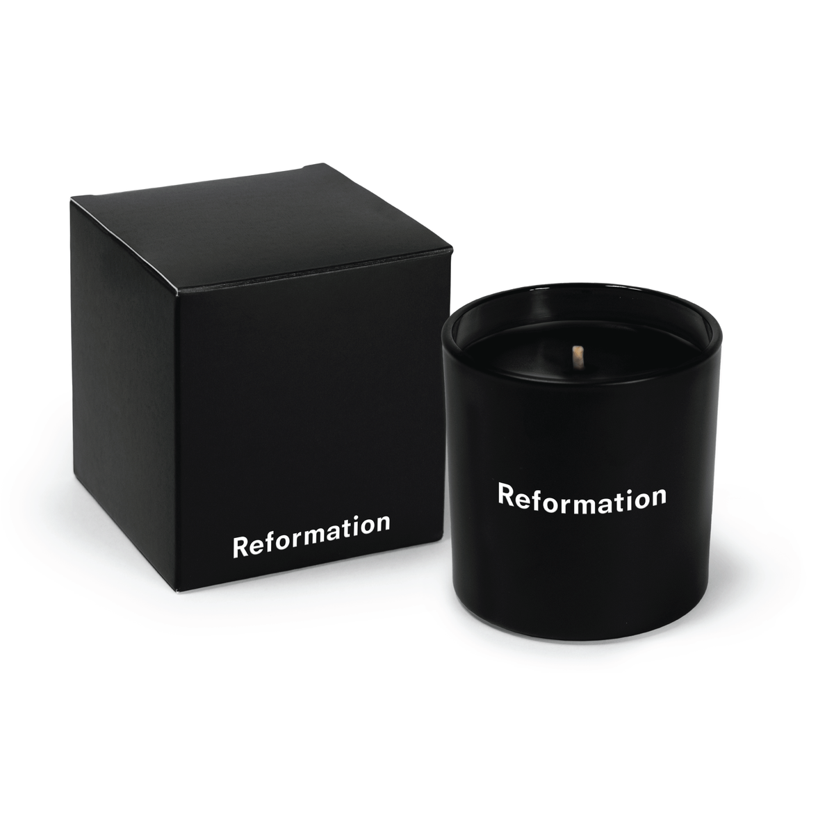 Black 9 oz candle with black wax and an open black gift box