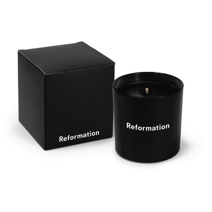 Black 9 oz candle with black wax and an open black gift box