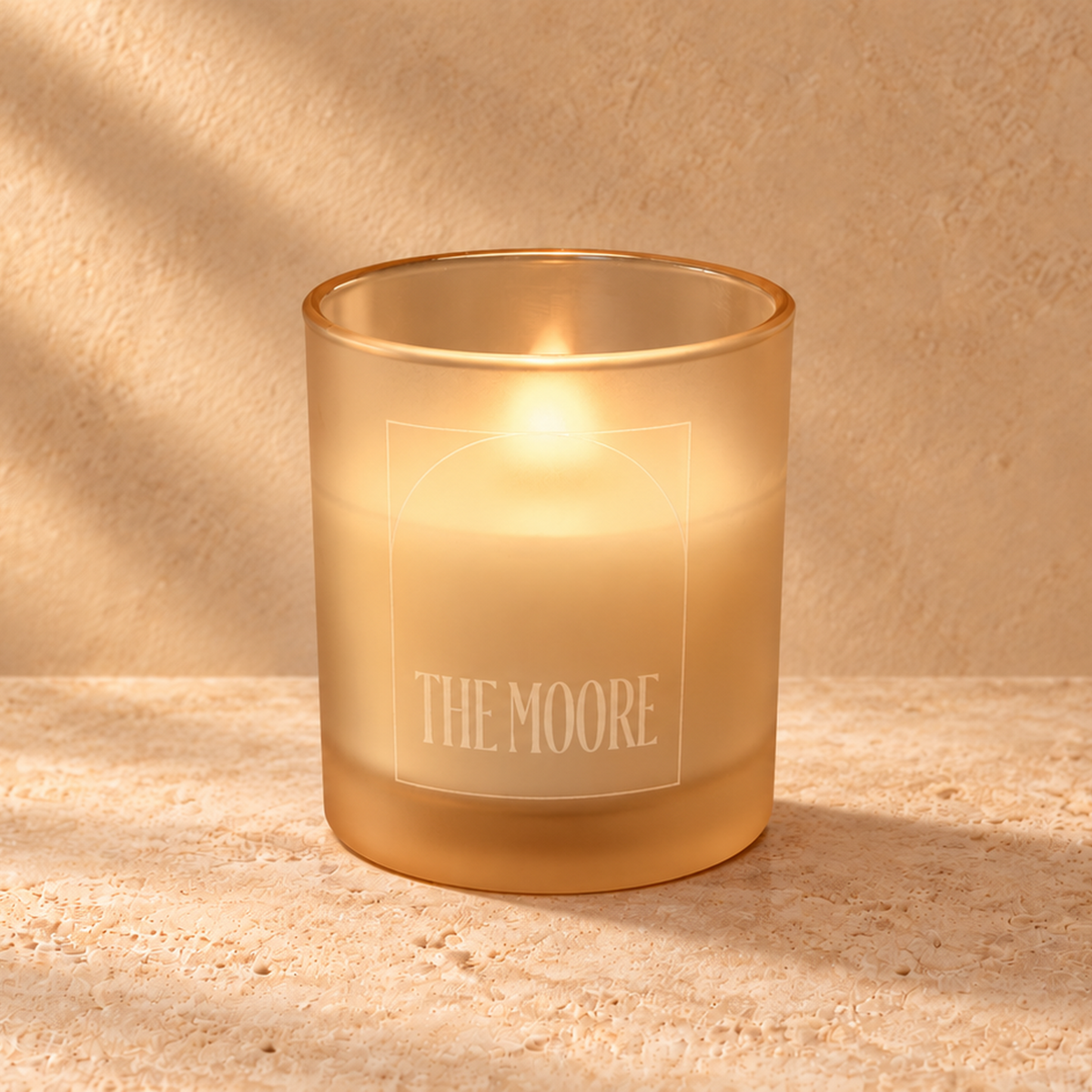 Sand 14 oz. Luxury Engraved Candle with a custom engraved logo, lit.