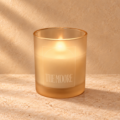 Sand 14 oz. Luxury Engraved Candle with a custom engraved logo, lit.