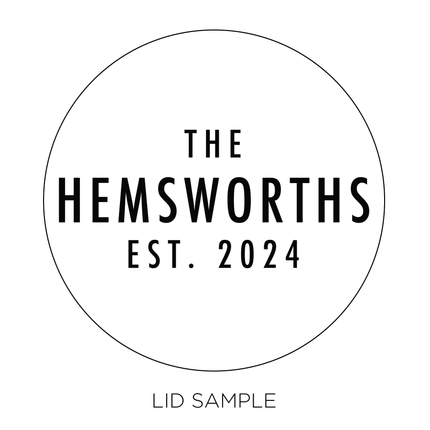 A sample of the wooden lid for the "Mr. & Mrs." candle by Custom Candles L.A. features the last name "The Hemsworths" with the established date "est. 2024" written below.