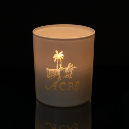 Matte White 14 oz. Luxury Engraved Candle lit, shown on a black background.