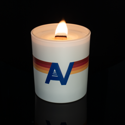 Matte White 14 oz. Luxury Printed Candle lit, shown on a black background.