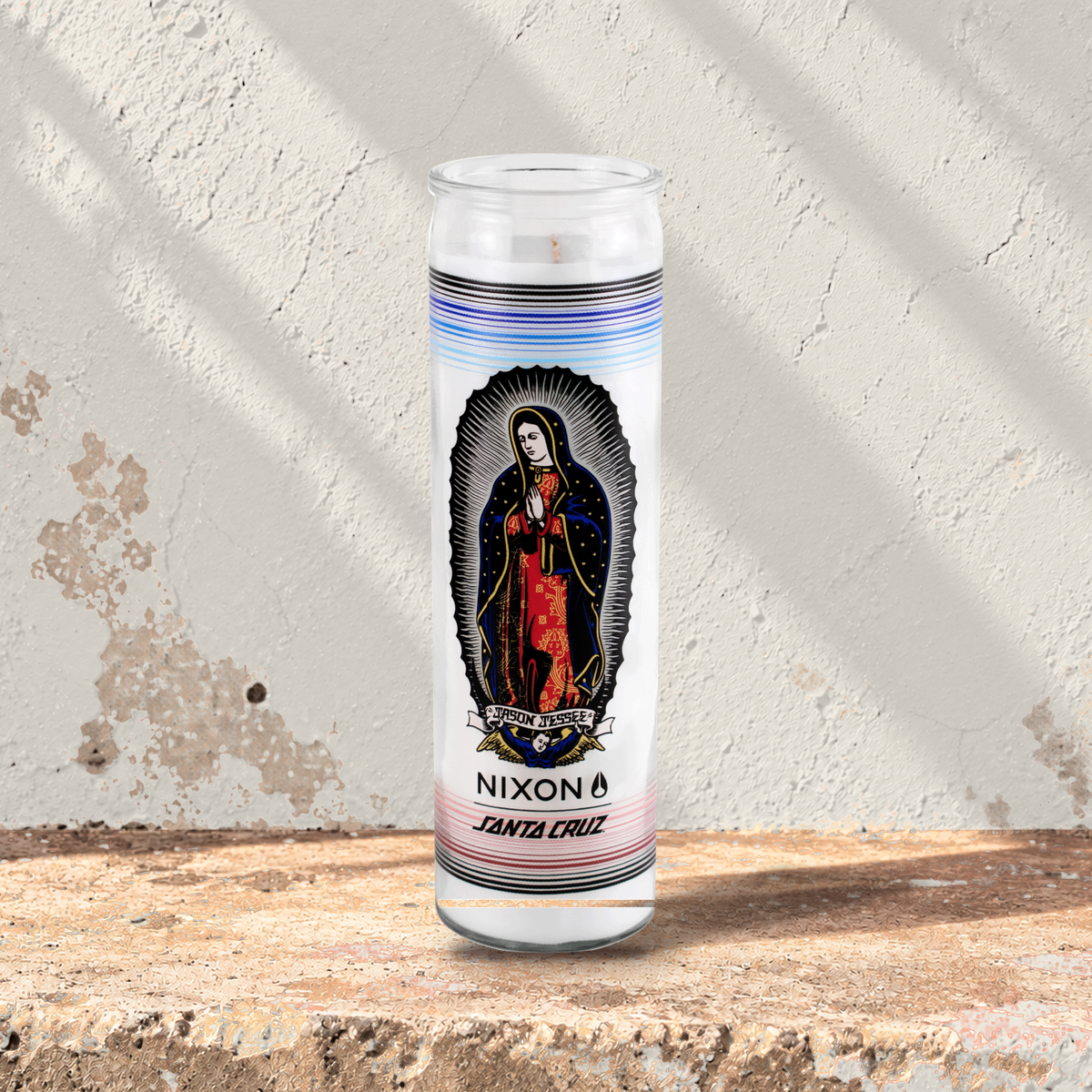 White 16 oz custom prayer candle printed with the Nixon Santa Cruz logo on a white background, unlit
